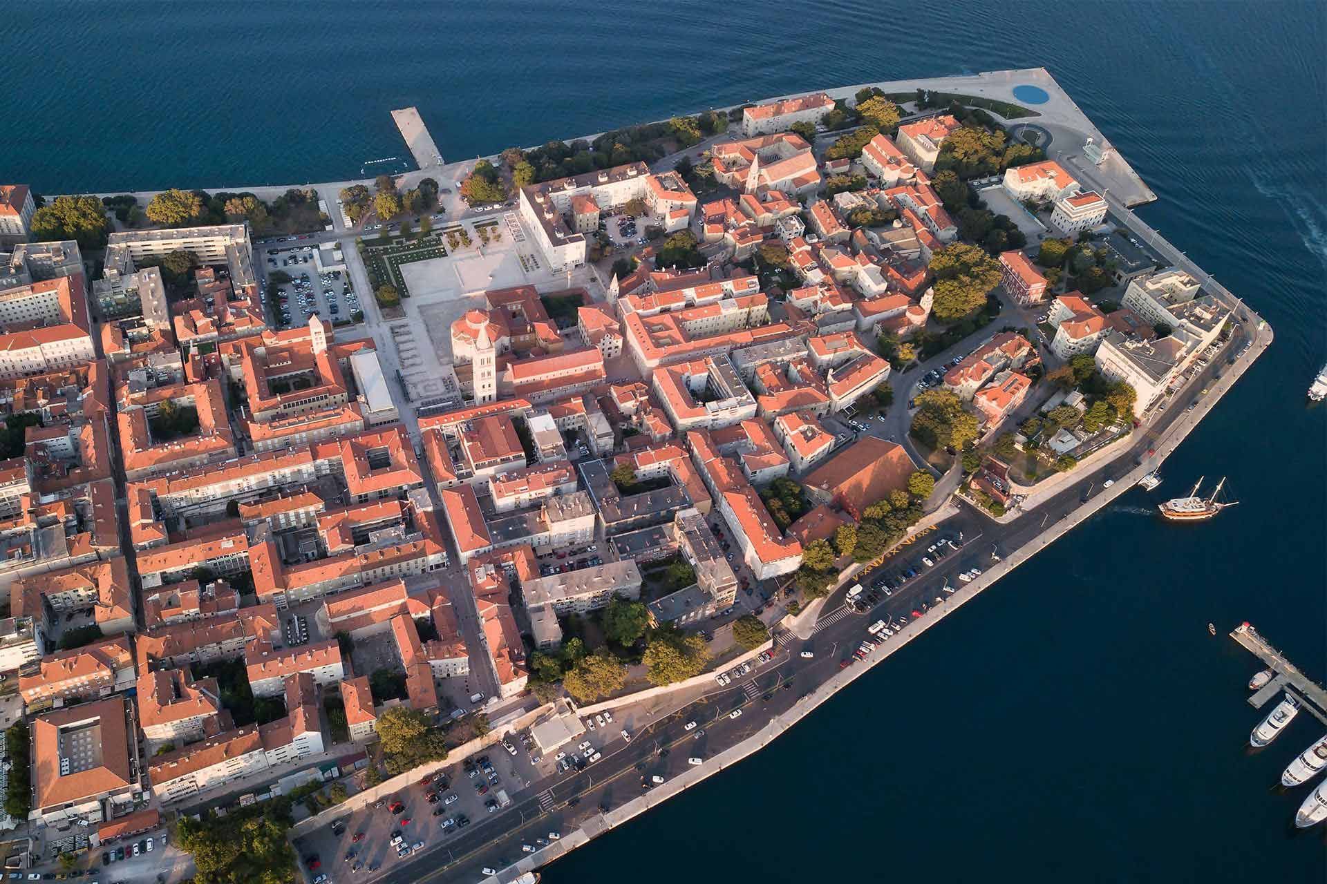 Mesmerizing aerial view of Zadar Old Town, Croatia, and Almayer Art & Heritage Hotel - an adults-only boutique hotel showcasing stunning architecture, vibrant culture, and scenic coastal beauty