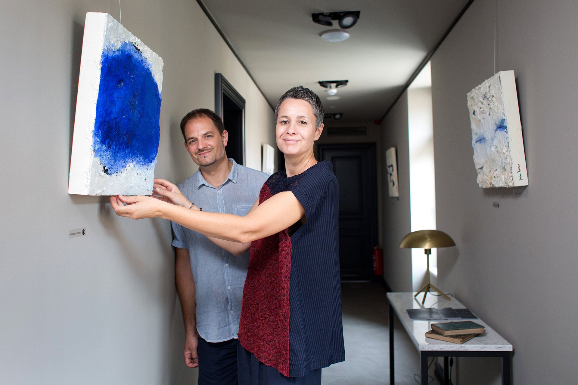 Owners of the Almayer Hotel, Irina Bakija and Vjekoslav Bobić, hang the Jasna Barišić’s painting