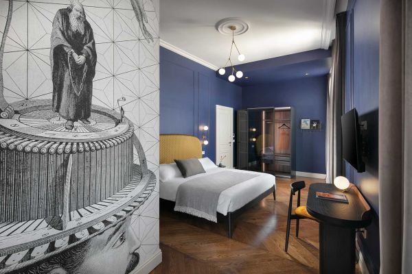 Unveiling captivating interior design: Superior double room 'Memento' at Almayer Art & Heritage Hotel's annexe building, with a king-sized bed and stylish table