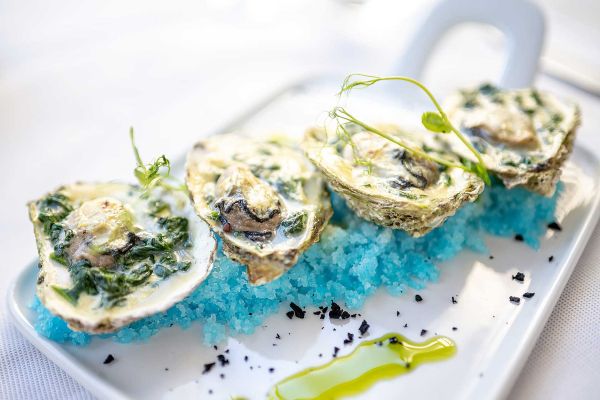 Savour fresh starters: Rockefeller oysters, an exquisite fine dining experience at Corte Restaurant, Almayer Art & Heritage Hotel