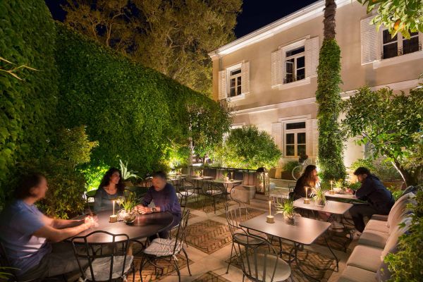 Experience the enchanting night-time dining ambience on Almayer's patio at Corte Restaurant, surrounded by a magical secret garden