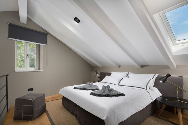 Bright mezzanine bedroom in Deluxe Mezzanine Double Room 'Bora' at Almayer Art & Heritage Hotel, featuring a versatile king-sized bed that can be separated into twin beds