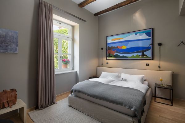 Immerse yourself in the charming interior of the Standard Double Room 'Ponente' at Almayer Art & Heritage Hotel, adorned with original artwork and a garden view