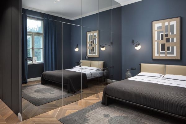 Chic Deluxe double room 'Bianchini' interior embraced by the mirrored wall at Almayer Art & Heritage Hotel's annexe building.