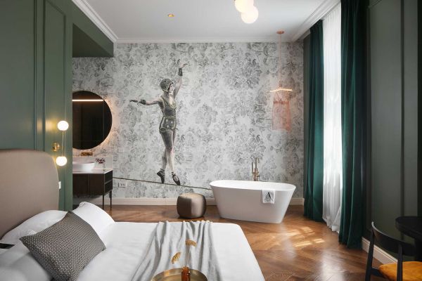 Indulge in luxury in the deluxe double room 'Gjika' at Almayer Art & Heritage Hotel's annexe building, with a spacious king-size bed and a relaxing bathtub