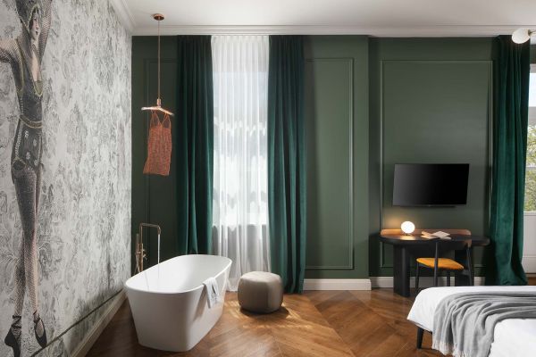 Relax and unwind in the inviting bathtub nestled within the Deluxe double room 'Gjika' at Almayer Art & Heritage Hotel's annexe building